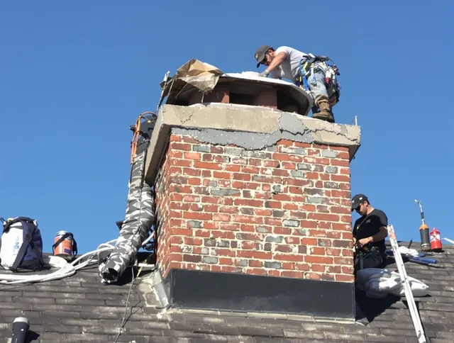 Seal Beach Chimney Sweep installing a custom chimney crown in Seal Beach, CA